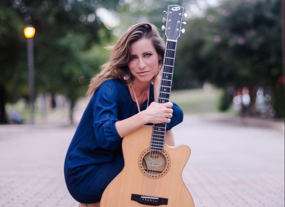 Elfin Paige Holding Her Guitar